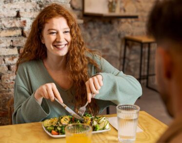 Smiley woman and man at restaurant