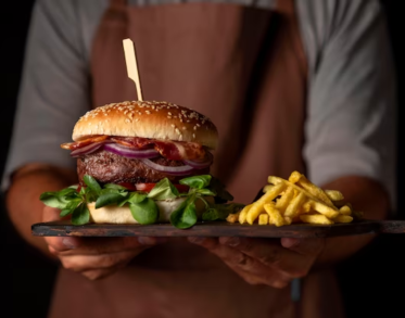 Man Holding Tray with Burger and Fries