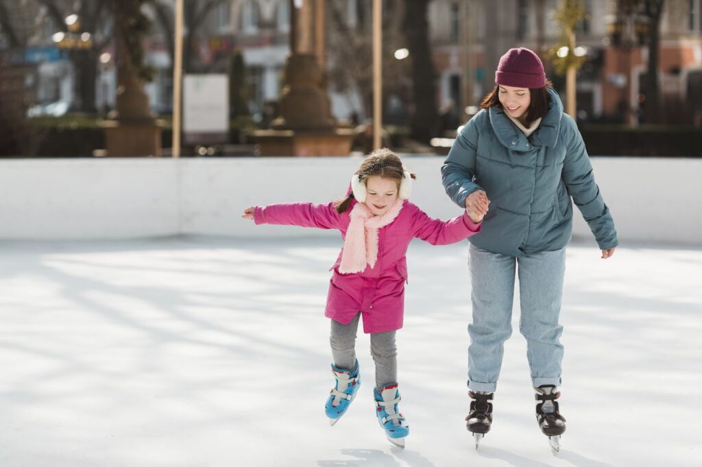 Kid and mother ice skating together