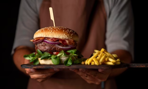 Man Holding Tray with Burger and Fries