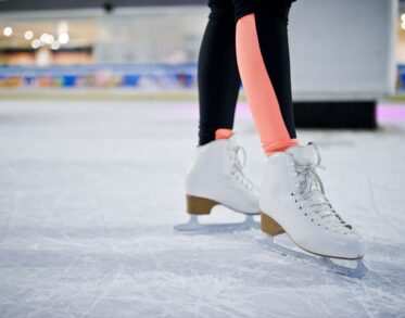 legs of ice skater on the ice rink