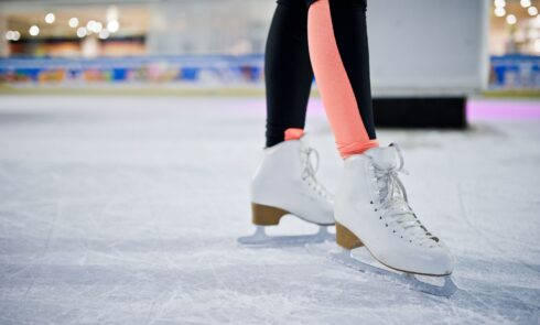 legs of ice skater on the ice rink