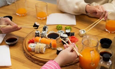 People eat sushi at the table