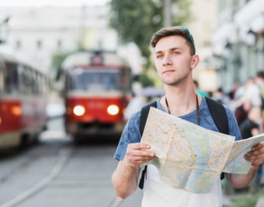 Man with a map on the background of a trolleybus