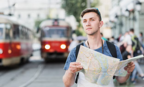 Man with a map on the background of a trolleybus