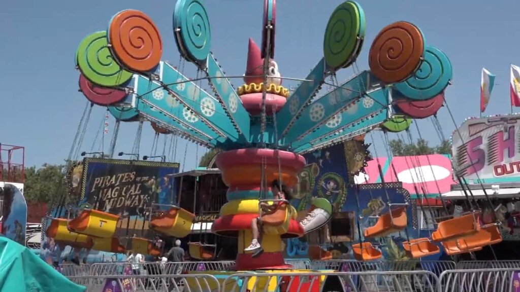 A whimsical carousel ride with vibrant spinning teacups at a fairground