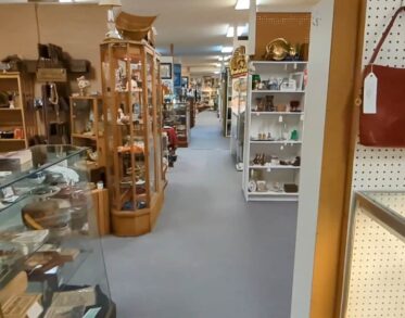 Interior view of an antique shop with aisles of goods