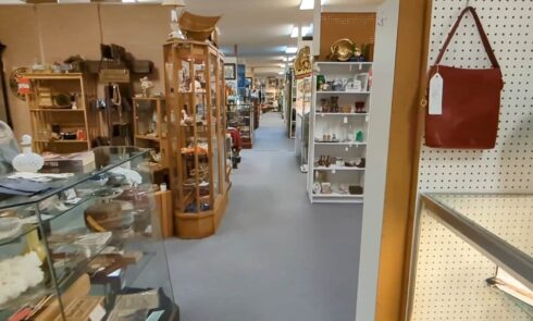 Interior view of an antique shop with aisles of goods