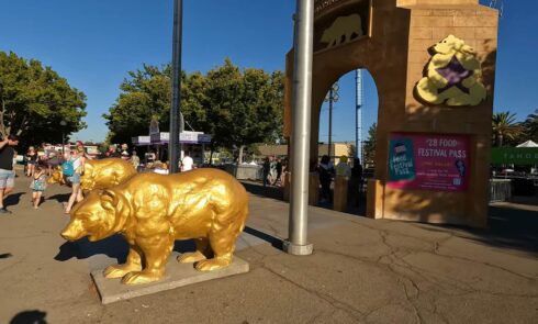A golden bear statue greets visitors at the entrance of the fair