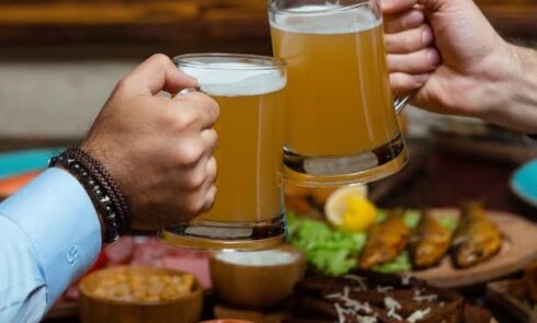 Two men drinking beer in a mug